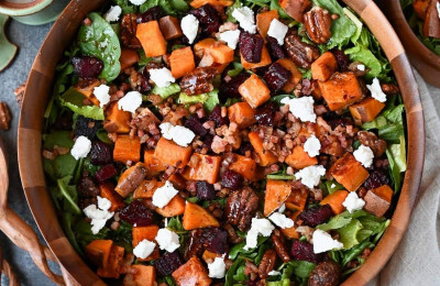 Salad of Roasted Sweet Potatoes and Beet Noodles Topped with Goat Cheese and Pistachio Dressing