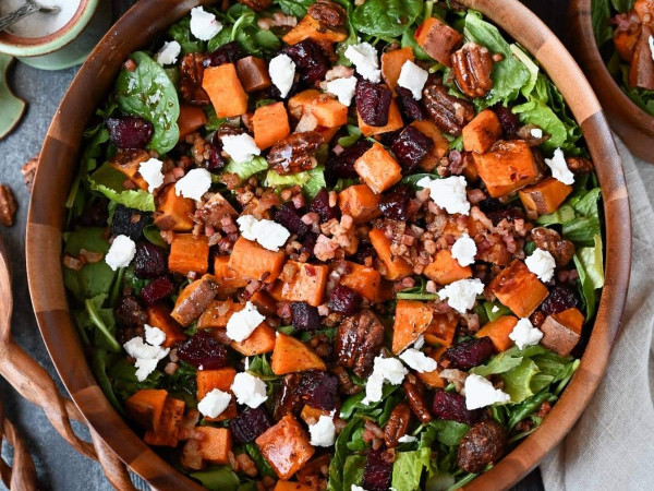 Salad of Roasted Sweet Potatoes and Beet Noodles Topped with Goat Cheese and Pistachio Dressing