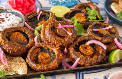 Grilled Portobello Caps Served with Mashed Cannellini Beans and Spicy Harissa